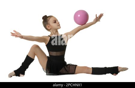 Cute little gymnast doing with ball on white background Stock Photo