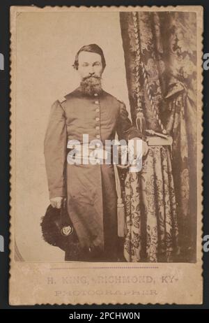 Captain John Wilson of Co. C, 8th Kentucky Infantry Regiment (Union), in uniform with sword; revolver and book rest on table / H. King, Richmond, Ky., photographer.. Liljenquist Family Collection of Civil War Photographs , pp/liljpaper. Wilson, John, 1822-1896, United States, Army, Kentucky Infantry Regiment, 8th (1862-1864), People, Soldiers, Union, 1860-1870, Military uniforms, Union, 1860-1870, Daggers & swords, 1860-1870, Handguns, 1860-1870, Books, 1860-1870, United States, History, Civil War, 1861-1865, Military personnel, Union. Stock Photo