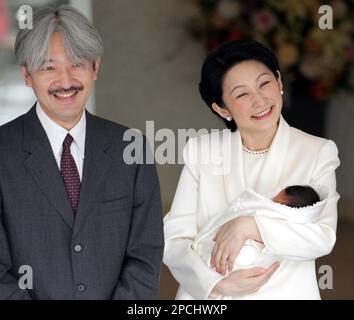 Princess Kiko, left, has Prince Hisahito watch carps on a pond as ... picture