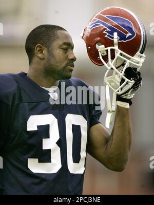 Buffalo Bills free safety Troy Vincent, left, and linebacker Takeo Spikes,  right, watch football practice inside the fieldhouse at Ralph Wilson  Stadium in Orchard Park, N.Y., Wednesday, Sept. 13, 2006. Spikes and