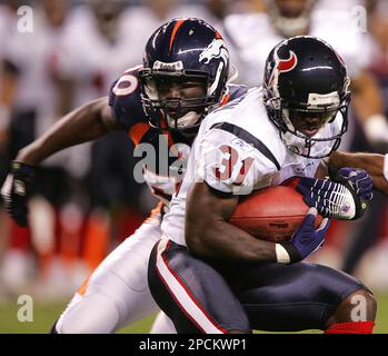 Denver Broncos linebacker Keith Burns jokes with teammates as the