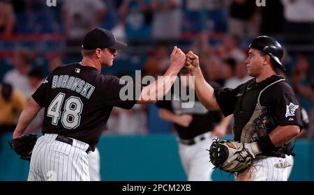 Florida Marlins' Miguel Olivo, right, celebrates with Aaron Boone