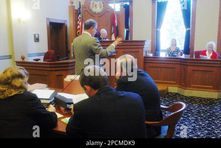 Attorney Burton Newman of Clayton Mo. standing center