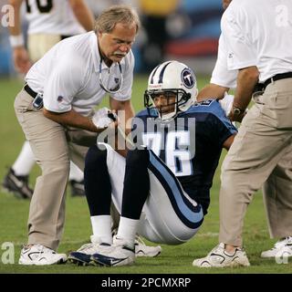 Tennessee Titans cornerback Andre Woolfolk is helped up by team