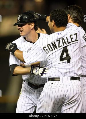 Arizona Diamondbacks' Luis Gonzalez, center, is greeted at home plate by  teammate Orlando Hudson, right, in front of St. Louis Cardinals catcher  Yadier Molina, left, after Gonzalez hit a two-run home run