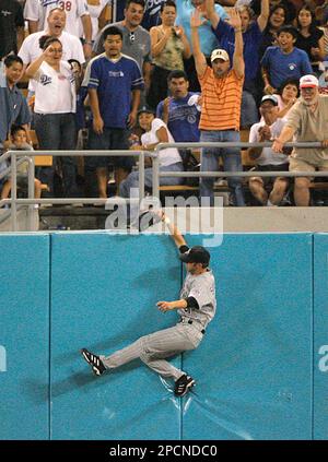 Colorado Rockies center fielder Cory Sullivan jumps and fails to catch a home run hit by Los Angeles Dodgers' Andre Ethier during the eighth inning of a baseball game in Los Angeles on Thursday, Aug. 10, 2006. (AP Photo/Jae C. Hong)