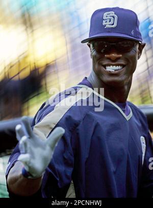 San Diego Padres center fielder Mike Cameron autographs a young