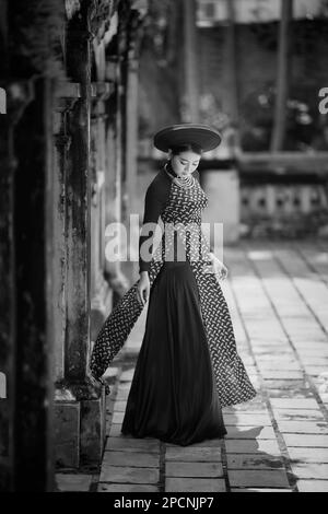 Beautiful Vietnamese Girl Wearing Black Luxury Color Ao Dai Stading At  Pagoda High-Res Stock Photo - Getty Images