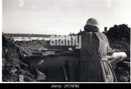 World War Two B&W photo German Soldier in a defensive position with a light MG34 on the Leningrad Front 1942 Stock Photo