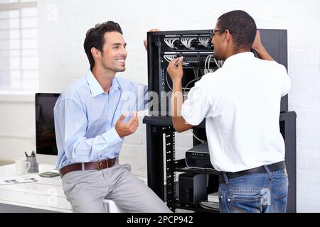 Wired for success. A young IT specialist ready to fix a server. Stock Photo