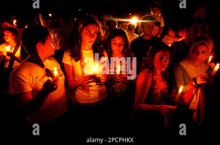 Lebanese hold a candlelit vigil in memory of at least 56 people