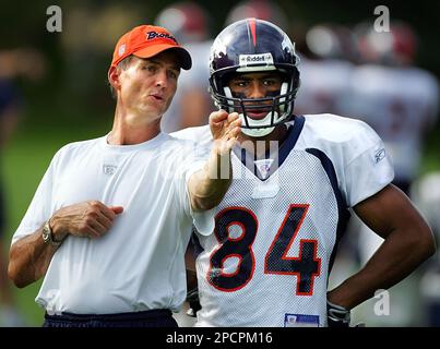 Denver Broncos wide receiver coach Steve Watson talks with Javon Walker  during the morning football training camp session at the Broncos'  headquarters in Denver, Monday, Aug. 8, 2006. (AP Photo/Jack Dempsey Stock