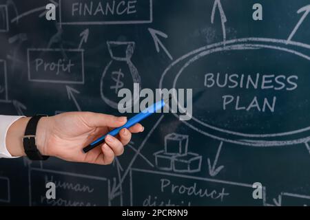 Business trainer with pen using interactive board, closeup Stock Photo