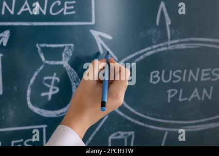 Business trainer with pen using interactive board, closeup Stock Photo