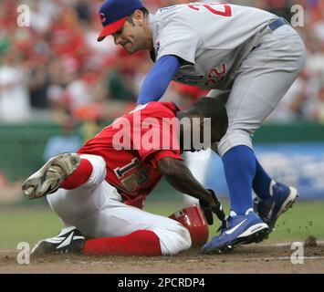 The Washington Nationals' Alfonso Soriano scores in front of Chicago Cubs'  pitcher Mark Prior after a wild pitch in the first inning of their game at  RFK Stadium in Washington, DC, on