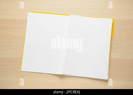 Yellow file with blank sheets of paper on wooden table, top view. Space for design Stock Photo