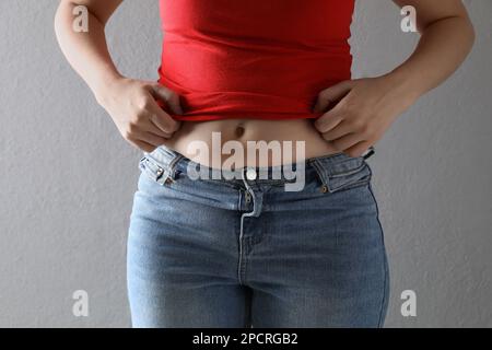 Foto de Woman wearing tight clothes on light grey background