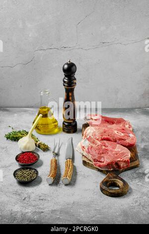 Raw lamb leg cut as a steak. Slices of shank on cutting board Stock Photo