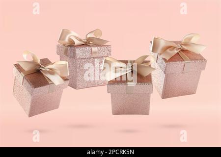 Beautifully wrapped gift boxes flying on pink background Stock Photo