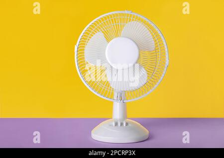 Electric fan on yellow background Stock Photo