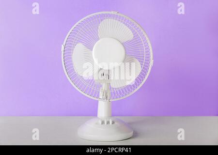Electric fan on lilac background Stock Photo