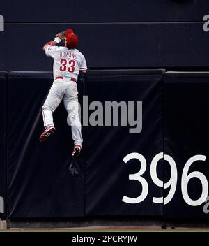 Philadelphia Phillies center fielder Aaron Rowand climbs he fence but  cannot reach a solo homer by San Diego Padres' MIke Cameron in the first  inning of their baseball game Monday, July 17