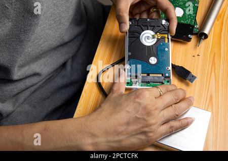 top view, man assembling an external hard drive Stock Photo
