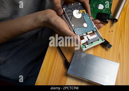 top view, man assembling an external hard drive Stock Photo