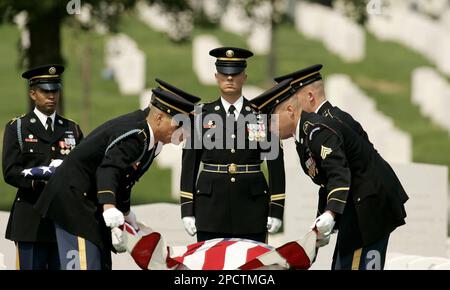 WASHINGTON, Aug. 14, 2014 -- Susan Myers presents a flower on the coffin of  her husband U.S. Army Maj. Gen. Harold Greene during a burial service at  section 60 of Arlington National