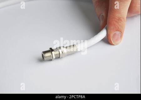 Close up on white TV cable connector. Stock Photo