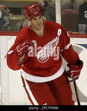 St. Louis Blues Christian Backman (55) comes over the shoulder of Detroit Red  Wings Brendan Shanahan as the two go after the puck in the first period at  the Savvis Center in
