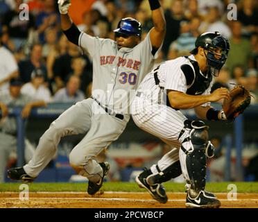 New York Mets Cliff Floyd is safe at home on a late tag by Atlanta Braves  catcher Brian McCann to score in the sixth inning July 29, 2006, in  Atlanta's Turner Field.