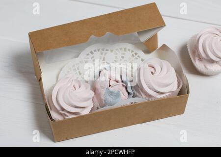 Homemade marshmallows in a cardboard box. Zephyr flowers. Gift wrap. Stock Photo