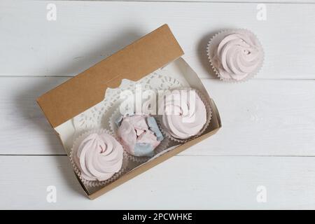 Homemade marshmallows in a cardboard box. Zephyr flowers. Gift wrap. Stock Photo