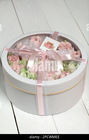 Homemade marshmallows in a cardboard box. Zephyr flowers. Box with transparent lid. Gift wrap. Tied with ribbon. Stock Photo