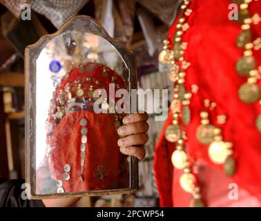 Bedouin woman in front of a mirror Stock Photo