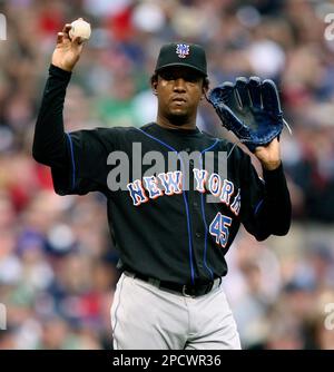 Pedro Martinez waves as he dons his new New York Mets jersey and cap during  a news conference at V Centennary Hotel in Santo Domingo, Dominican  Republic, Friday, Dec. 17, 2004. Martinez