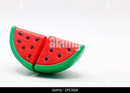 a plastic toy watermelon on a white background Stock Photo