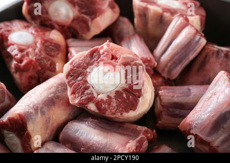 Raw pieces of oxtail with bone, gelatin-rich meat, usually slow-cooked as a stew or braised, traditional stock base for oxtail soup, selected focus, n Stock Photo