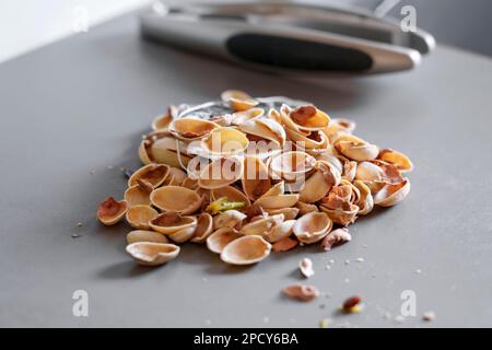 A pile of kitchen scraps. Pistachio nutshell on the kitchen table Stock Photo