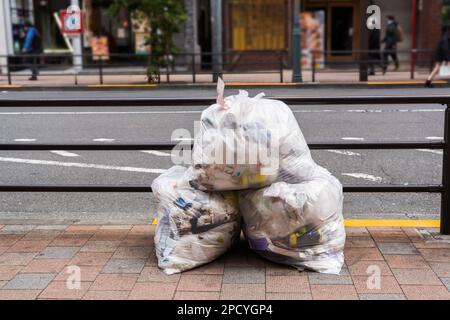 A pile of trash bag on a footpath in Tokyo, Japan Stock Photo
