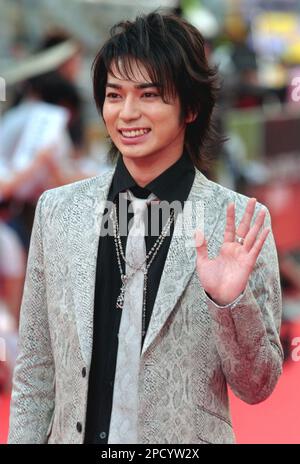 Japanese singer Jun Matsumoto smiles as he arrives at the 17th