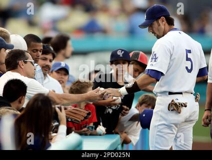 Five-time All-Star Nomar Garciaparra, right, holds his new Los Angeles  Dodgers' jersey with his wife, former soccer star Mia Hamm, during a news  conference announcing his signing a one-year contract with the