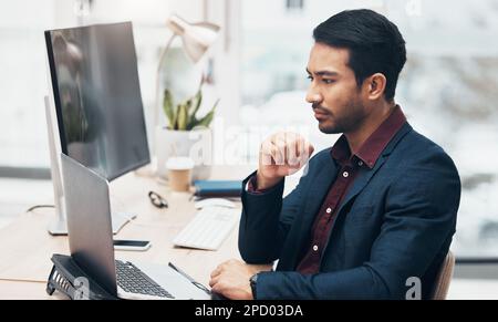 Office, brainstorming and man at computer thinking of ideas for online project with concentration and focus. Planning, analytics and Indian Stock Photo