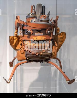 An eccentric looking Loewe leather backpack on display with a variety of items on top Stock Photo