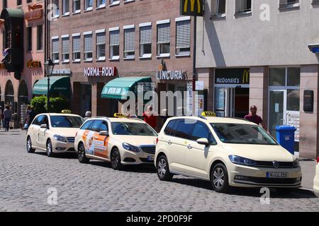 NUREMBERG, GERMANY - MAY 8, 2018: Taxi cabs parked in the main square Hauptmarkt in Nuremberg, Germany. Nuremberg is located in Middle Franconia. Stock Photo