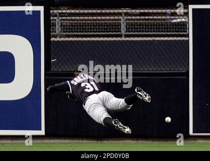 Colorado Rockies center fielder Cory Sullivan dives as he fails to catch a ball hit for a RBI triple by Diego Padres' Khalil Greene in the fourth inning of an MLB baseball game Tuesday, May 30, 2006, in San Diego. (AP Photo/Lenny Ignelzi)