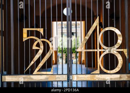 52 Fifty-two and 48 Forty-Eight numbers made in beautoful vintage font on the gate of a property in Provence South of France Stock Photo