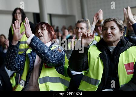 Berlin, Germany. 14th Mar, 2023. Participants in a strike meeting clap at an event during warning strikes at hospitals in Berlin. Credit: Carsten Koall/dpa/Alamy Live News Stock Photo