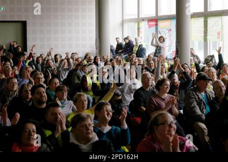 Berlin, Germany. 14th Mar, 2023. Participants in a strike meeting clap at an event during warning strikes at hospitals in Berlin. Credit: Carsten Koall/dpa/Alamy Live News Stock Photo